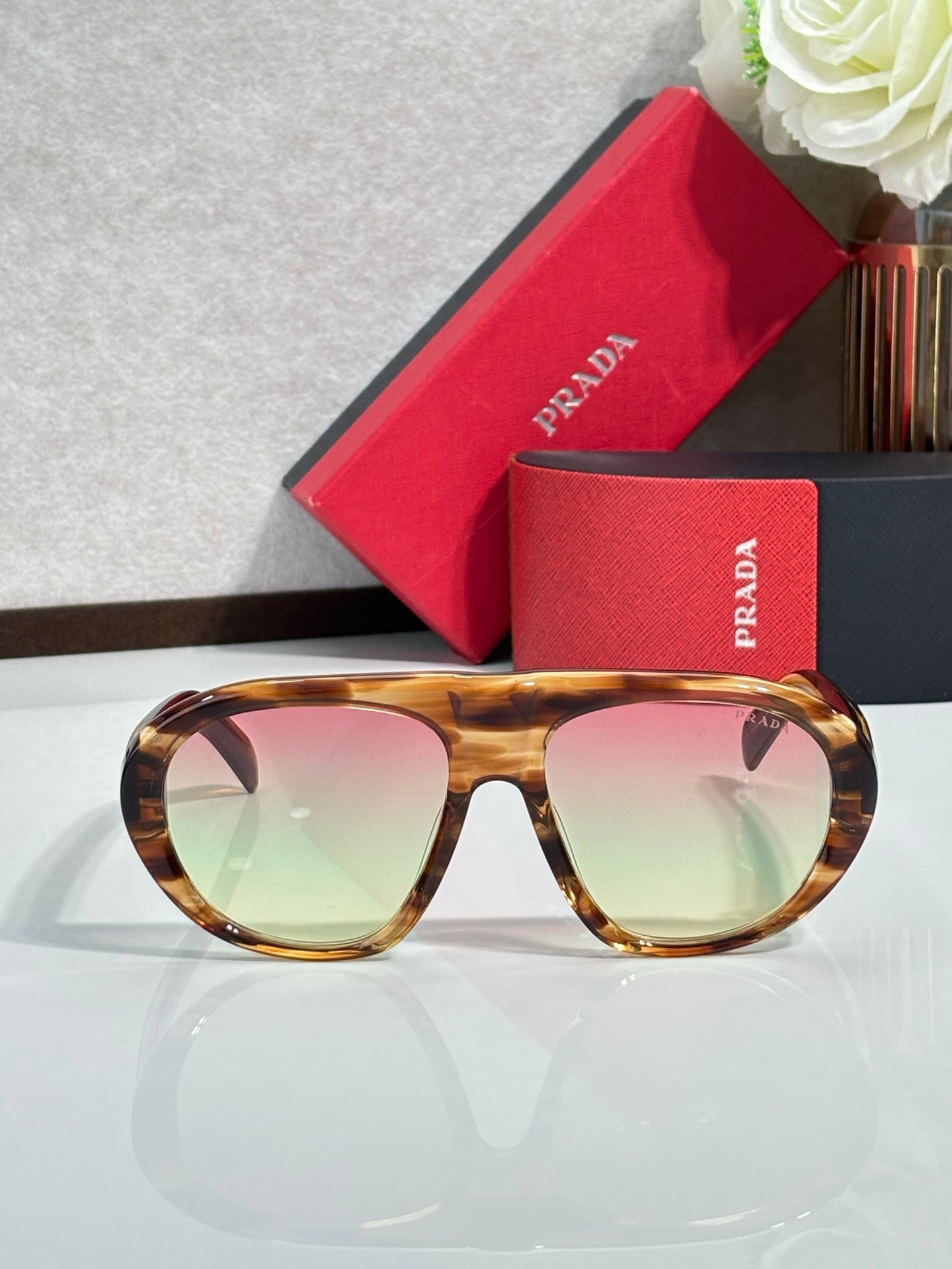 Prada glasses, tortoiseshell full-rim frame with pink-to-green tinted lenses