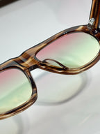 Prada glasses close-up of tortoiseshell frame edge and tinted lens