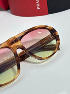 Prada glasses front rim close-up with tortoiseshell frame and tinted lens