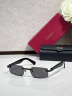 Cartier sunglasses with black frame and dark lenses, glossy temple detailing