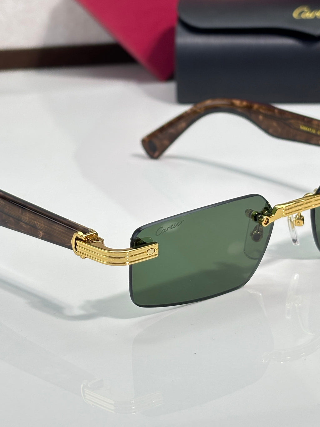 Cartier sunglasses with tortoiseshell arms, green lenses and gold-tone hinge