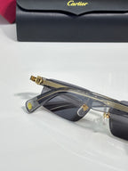 Cartier sunglasses with dark lenses, gold bridge, and visible top bar