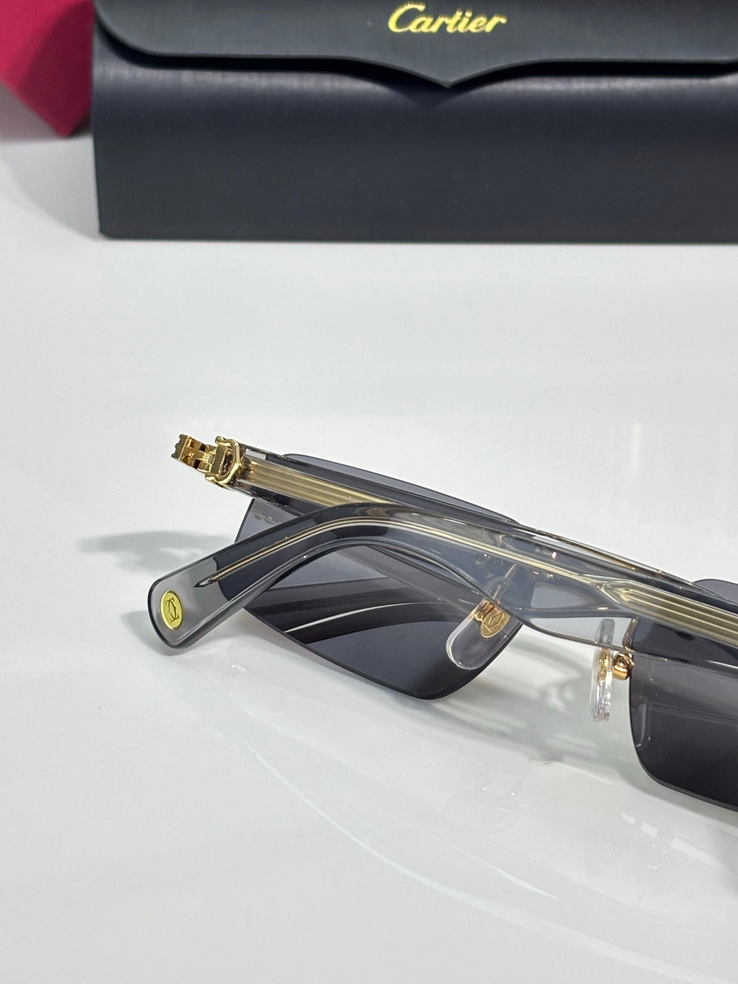 Cartier sunglasses with dark lenses, gold bridge, and visible top bar