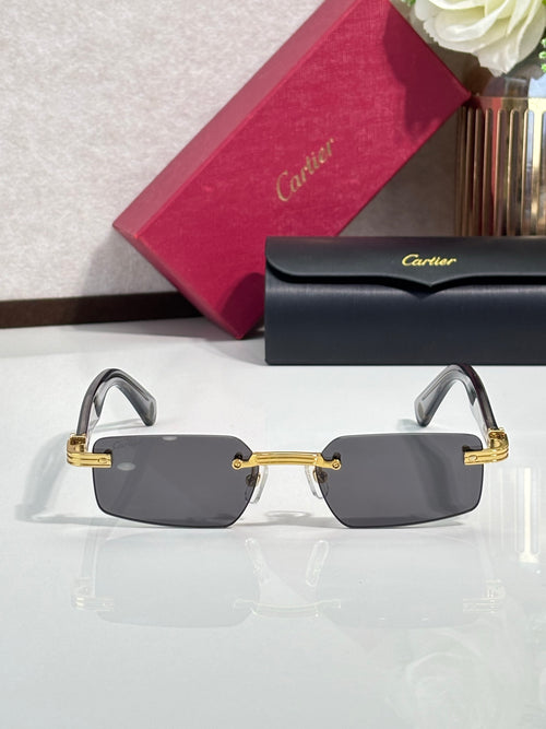 Cartier dark rectangular sunglasses with gold metal frame and angular temples