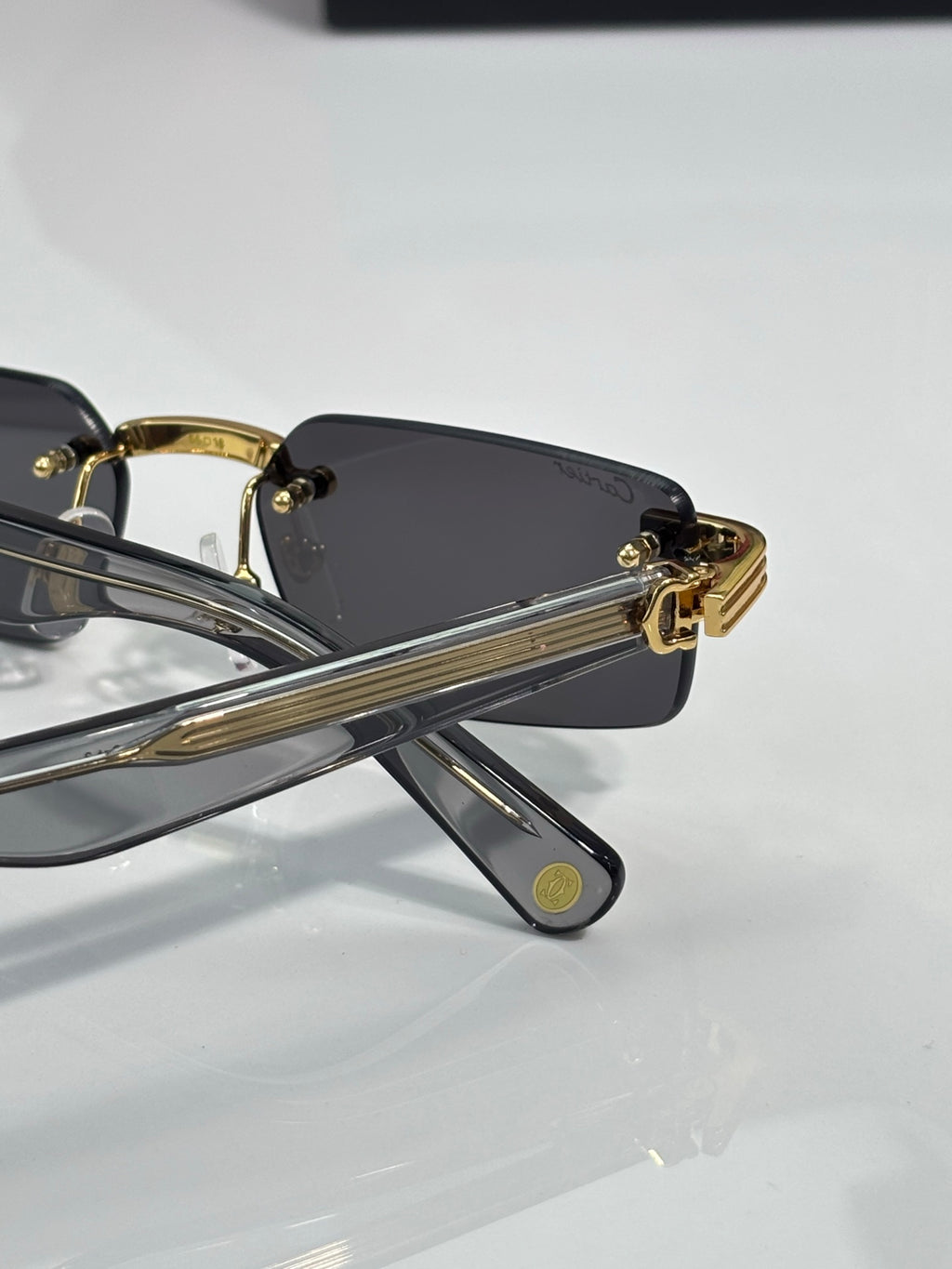 Cartier sunglasses side view with gold frame arms and dark lens
