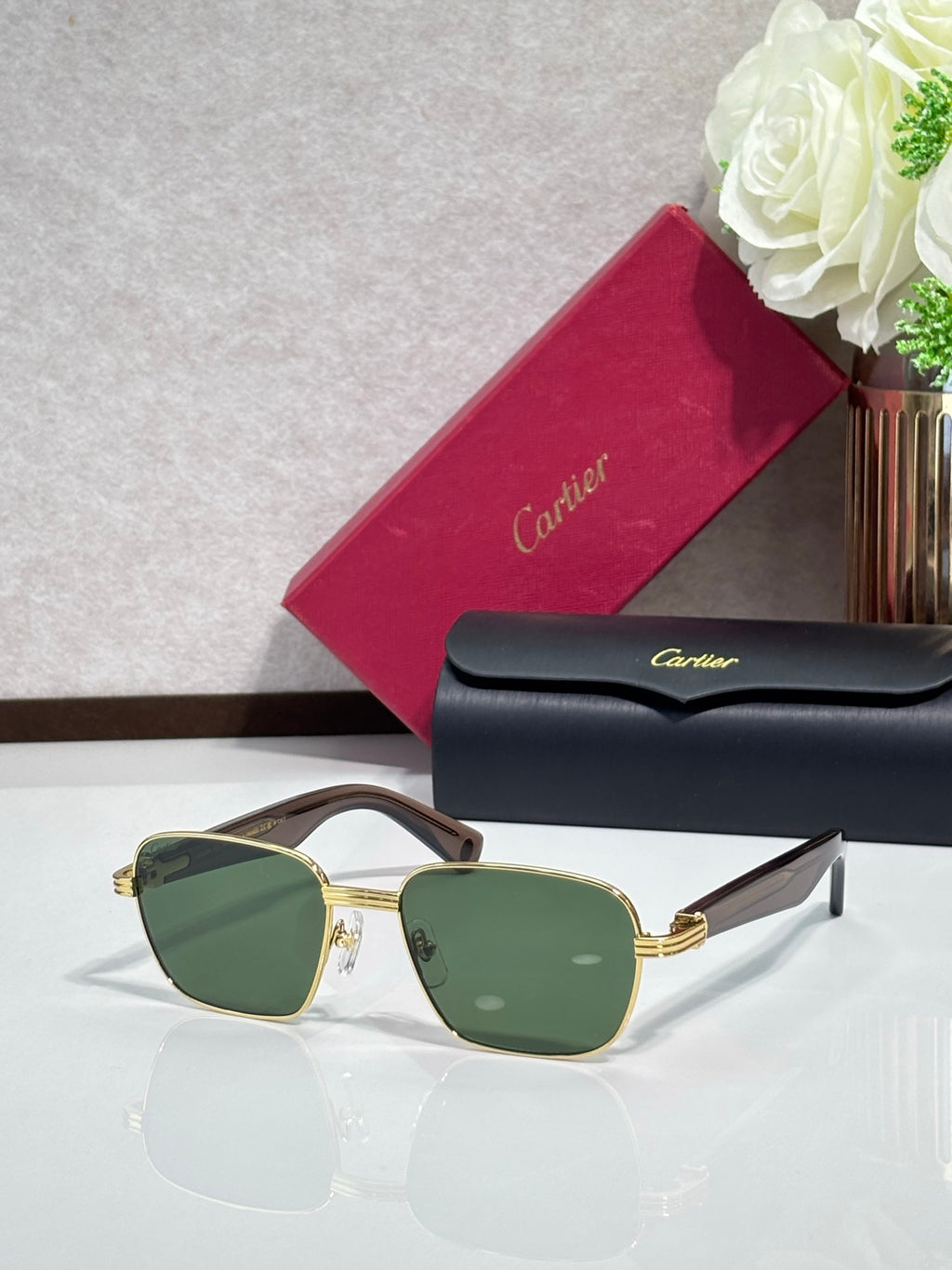 Cartier sunglasses with gold frames and green-tinted lenses
