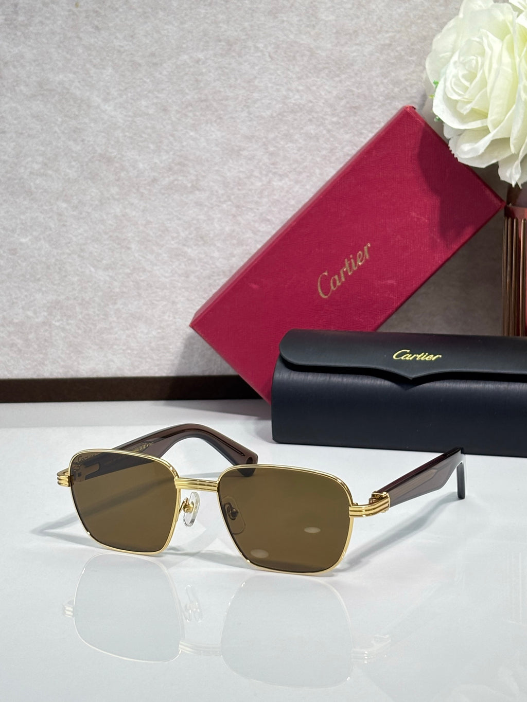 Cartier sunglasses with gold frames and brown-tinted lenses