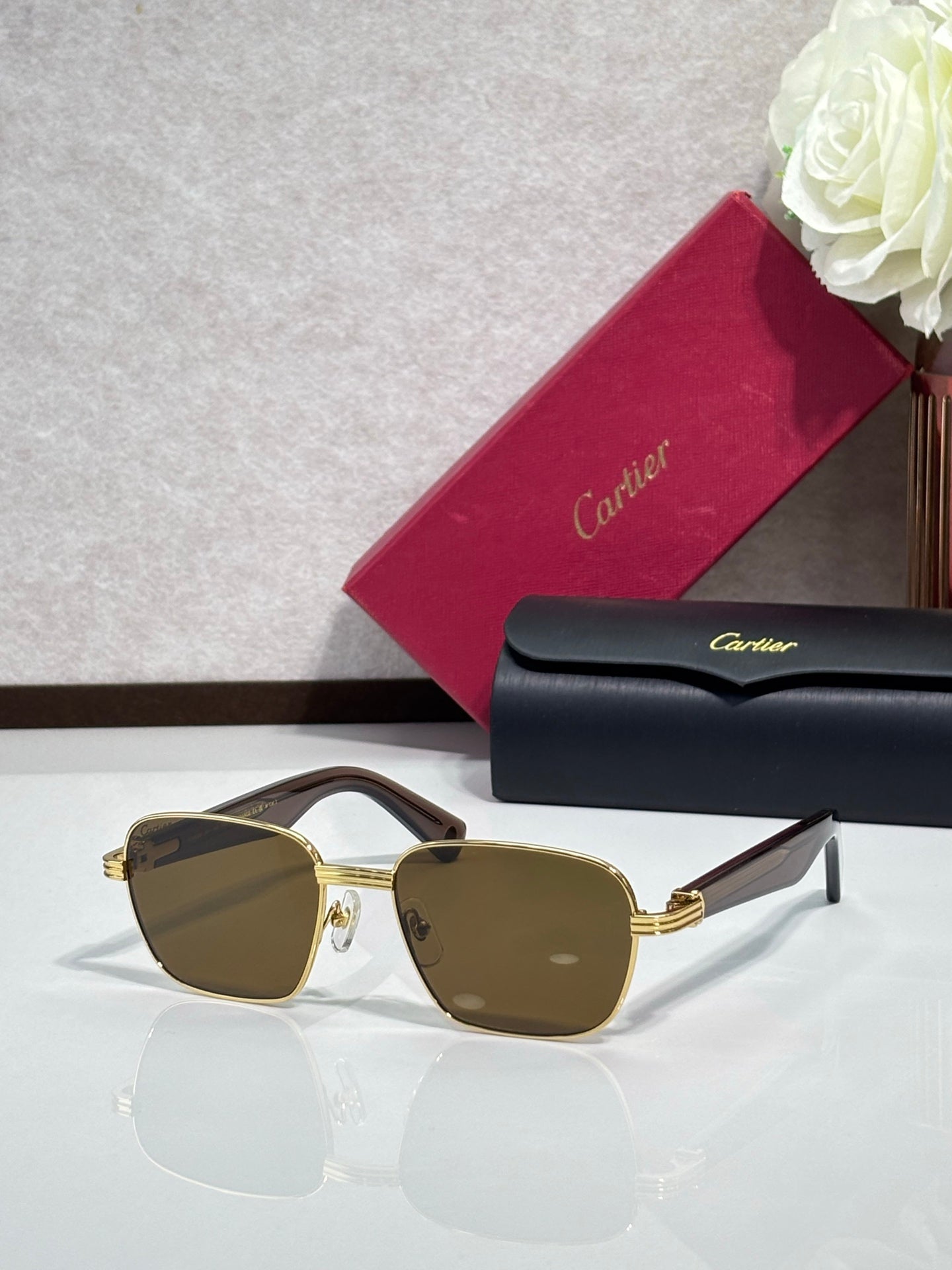 Cartier sunglasses with gold frames and brown-tinted lenses