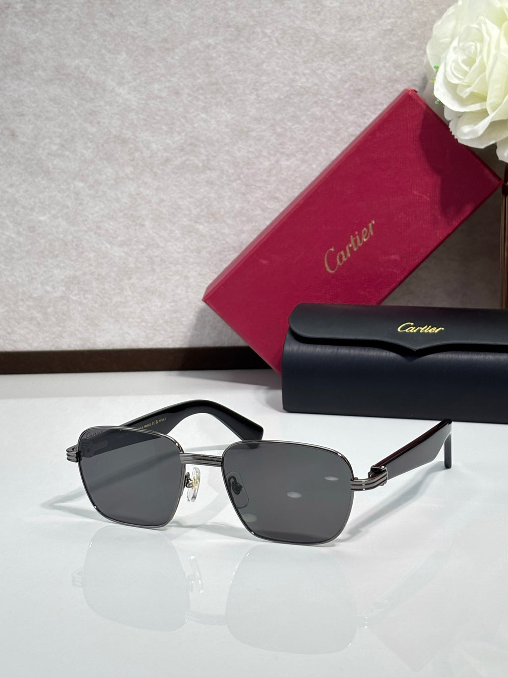 Cartier sunglasses with dark frames and gray lenses