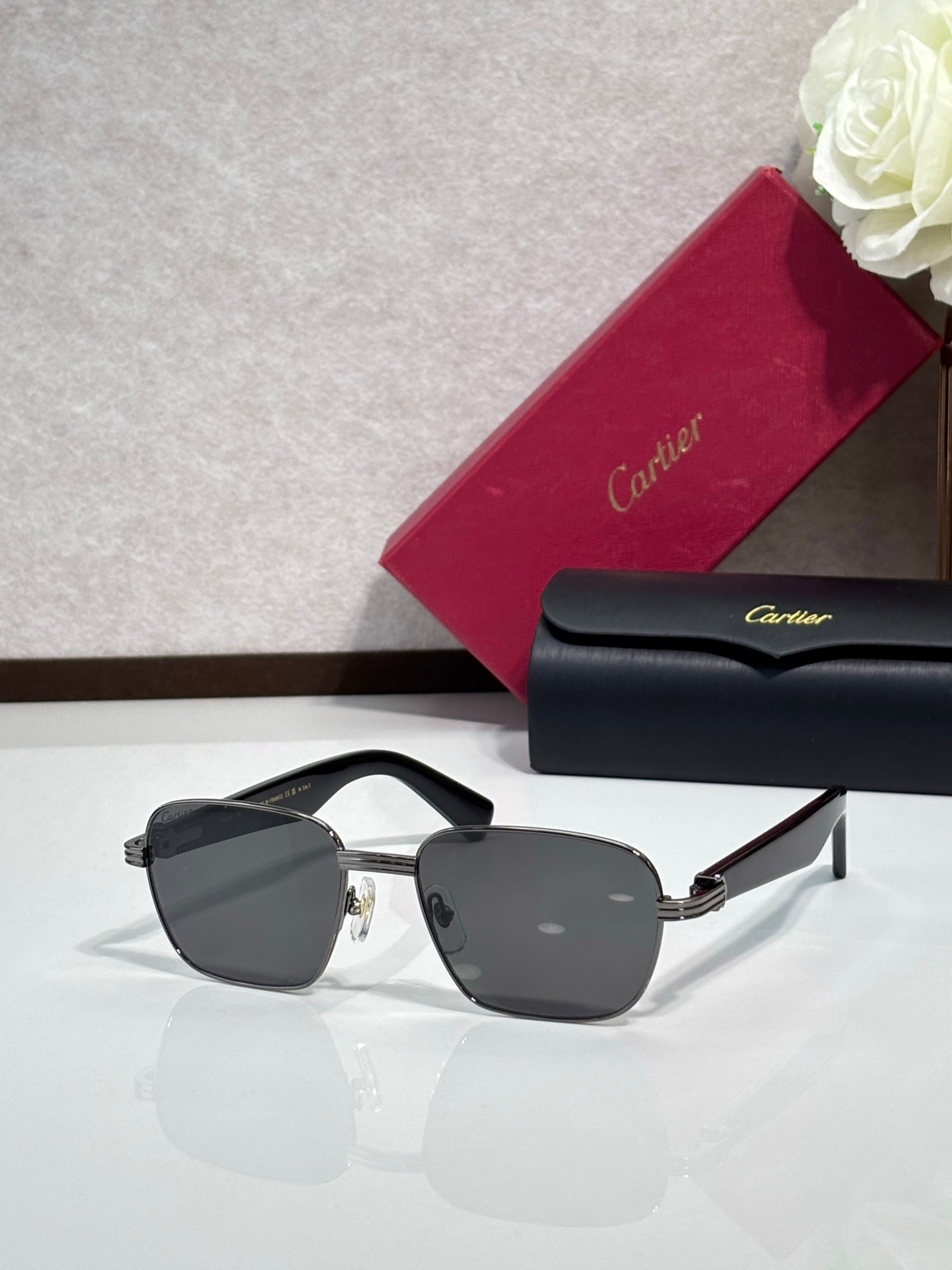 Cartier sunglasses with dark frames and gray lenses