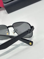 Cartier sunglasses side view with black frame and dark lenses, logo on temple