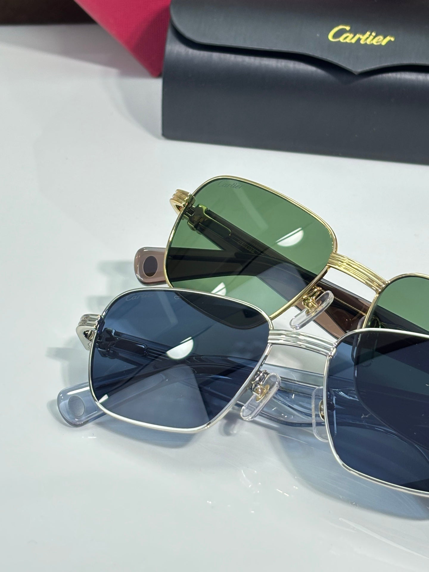 Cartier sunglasses trio with green, blue, and dark lenses and gold rims