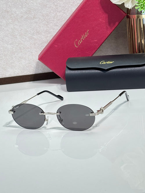 Round dark gray sunglasses with gold-tone metal frame, thin arms, and gold accents