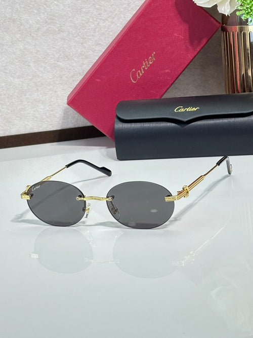 Round dark gray sunglasses with gold-tone metal frame and thin gold temple details
