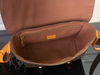 Louis Vuitton bag interior with tan lining and zipper pocket, open top view