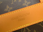 Louis Vuitton PARIS embossed on tan leather strap with yellow stitching close-up