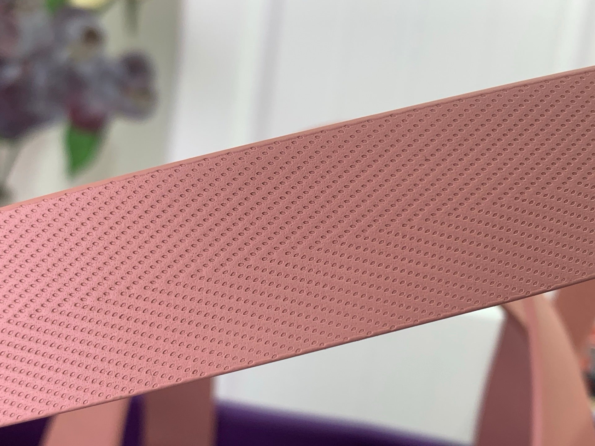 Tan textured strap close-up on purple bag