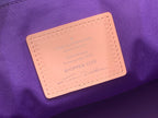 Orange leather label patch on purple tote bag