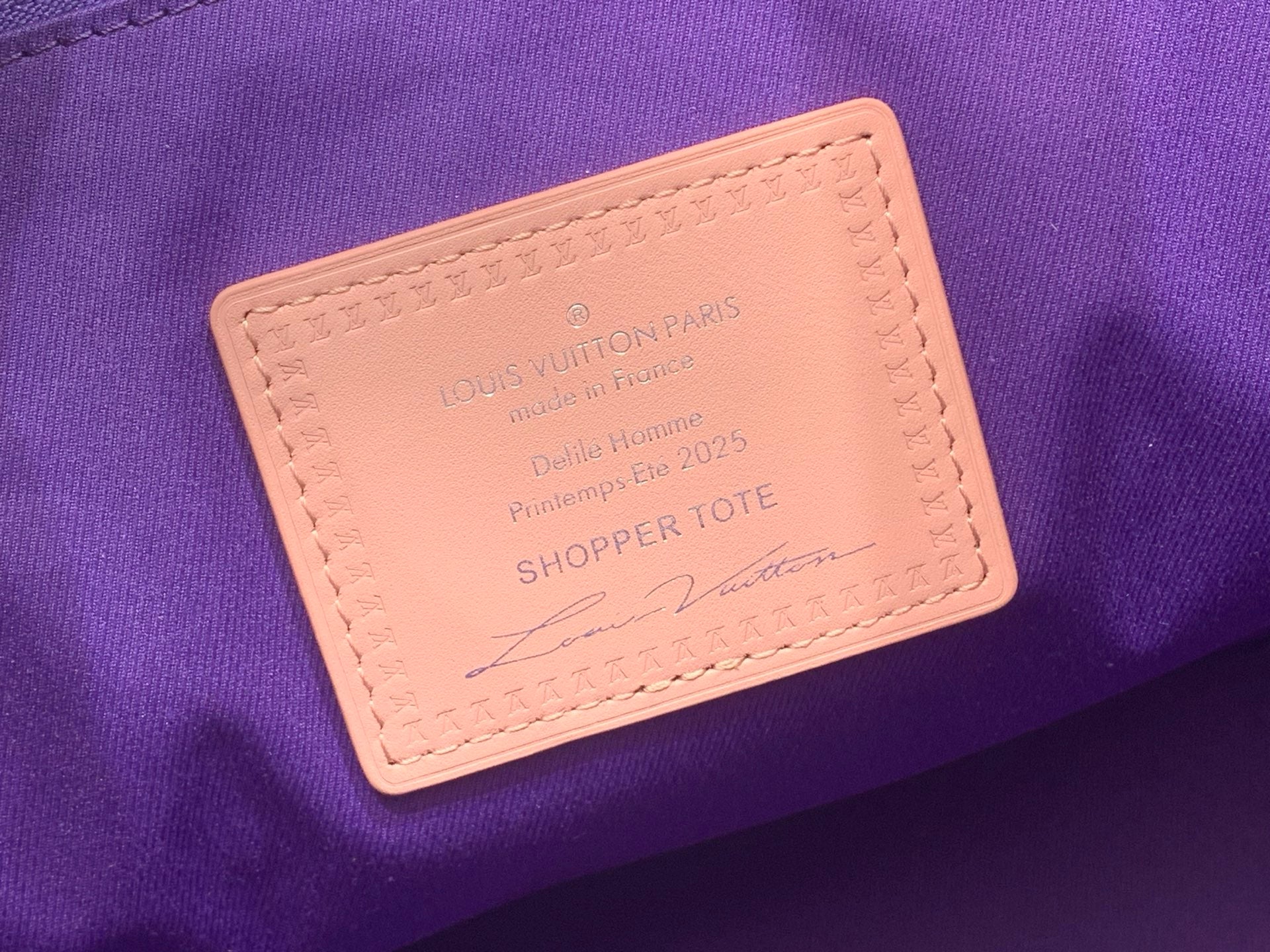 Orange leather label patch on purple tote bag