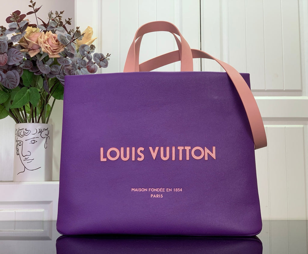 Purple tote bag with tan handles and Louis Vuitton logo on front