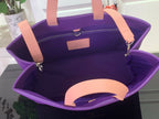 Purple tote bag interior with tan handles and zip pocket