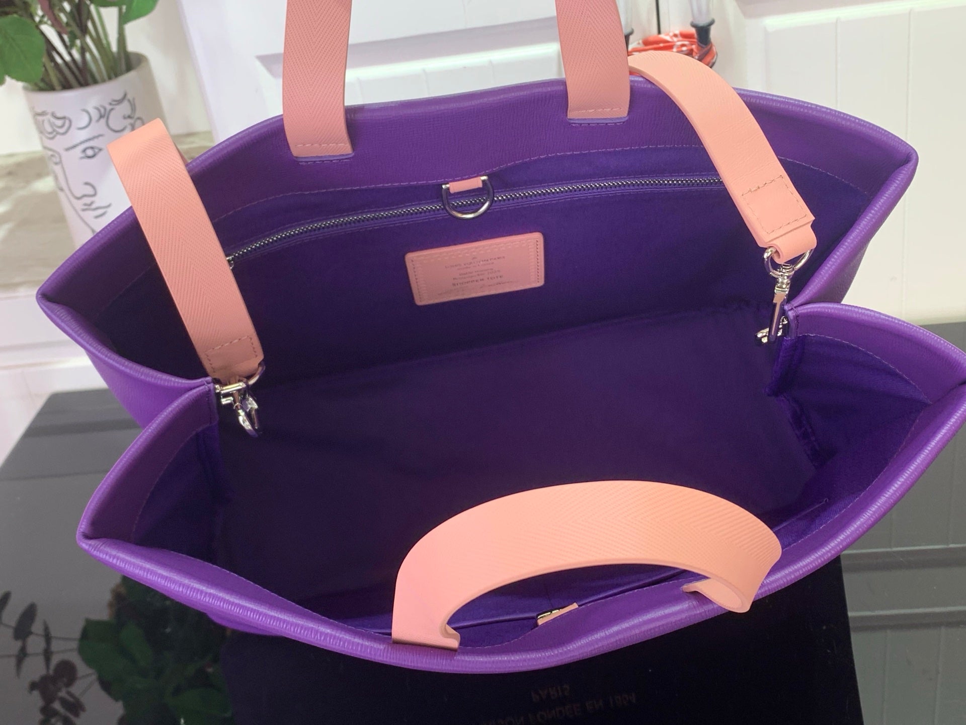 Purple tote bag interior with tan handles and zip pocket