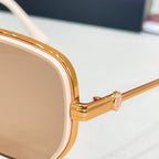 Cartier sunglasses temple close-up, gold-tone arm with decorative details