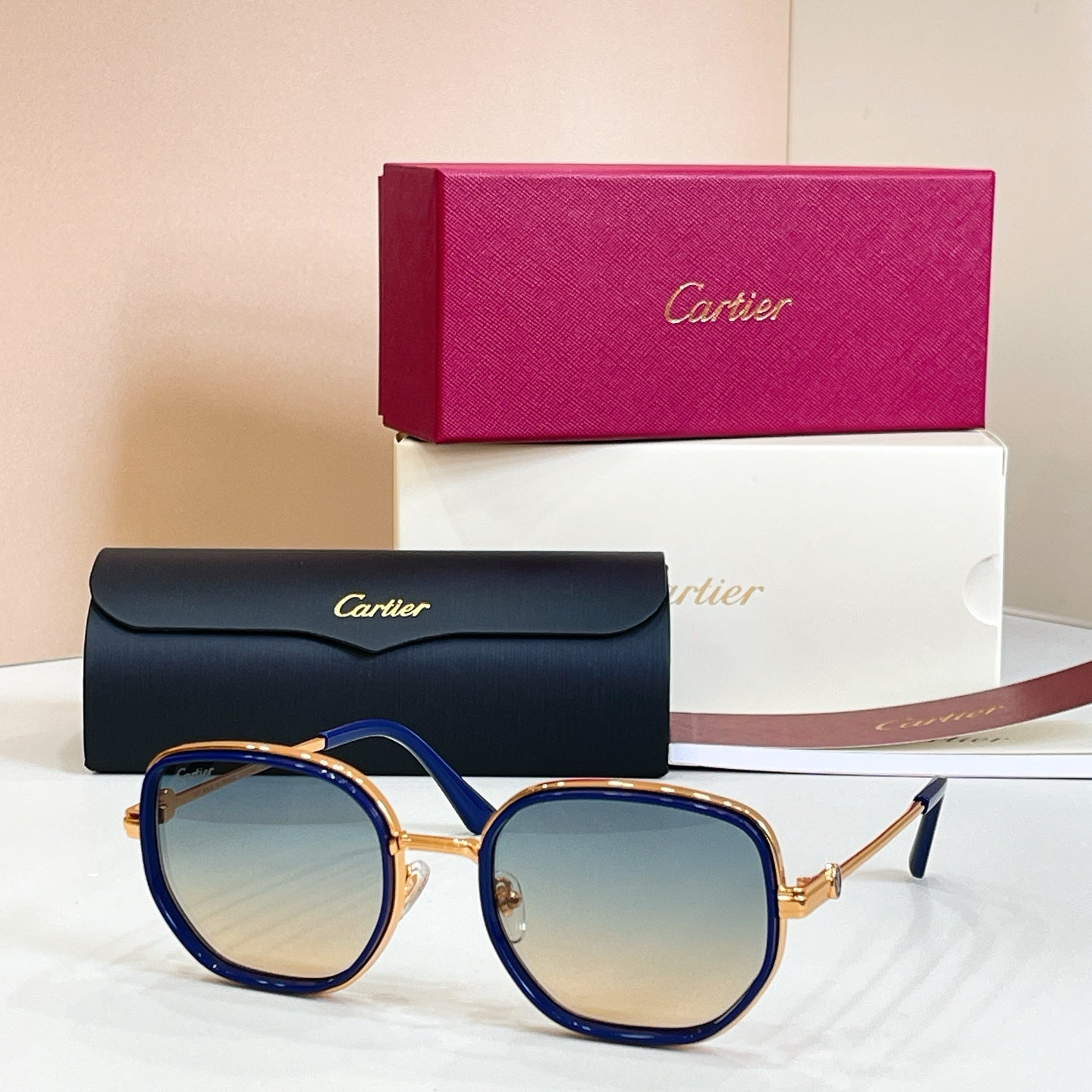 Cartier round sunglasses, blue frames with gold-tone rims and gradient tinted lenses