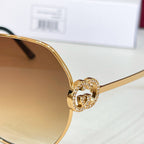 Gold sunglasses hinge with pavé logo detail on the temple