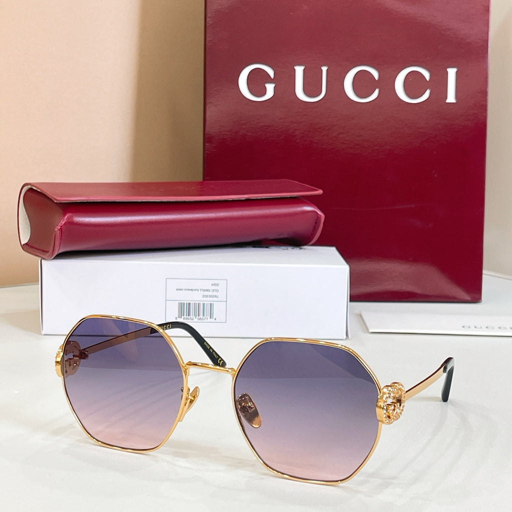 Gold round sunglasses with purple tinted lenses and gold-toned arms
