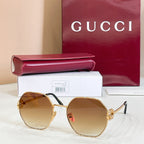 Gold round sunglasses with amber tinted lenses and gold-toned arms