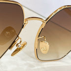 Gold sunglasses with hinged detail and amber tinted lenses