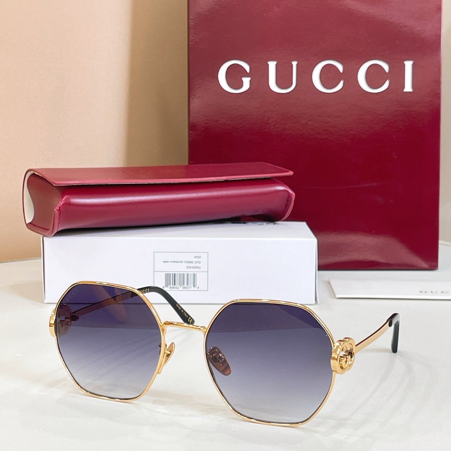 Gold round sunglasses with blue tinted lenses and black temple tips