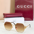 Gold round sunglasses with amber tinted lenses and thin black temples