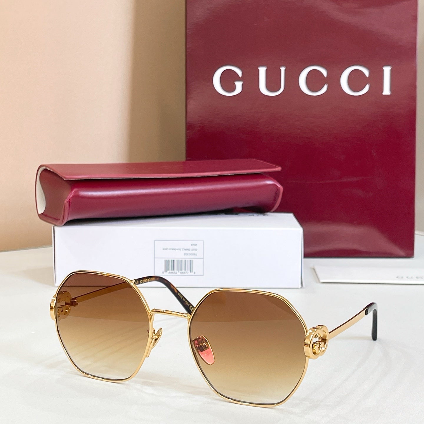 Gold round sunglasses with amber tinted lenses and thin black temples