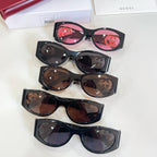 Set of Gucci sunglasses with black frames and mixed lenses: pink, brown, and gray