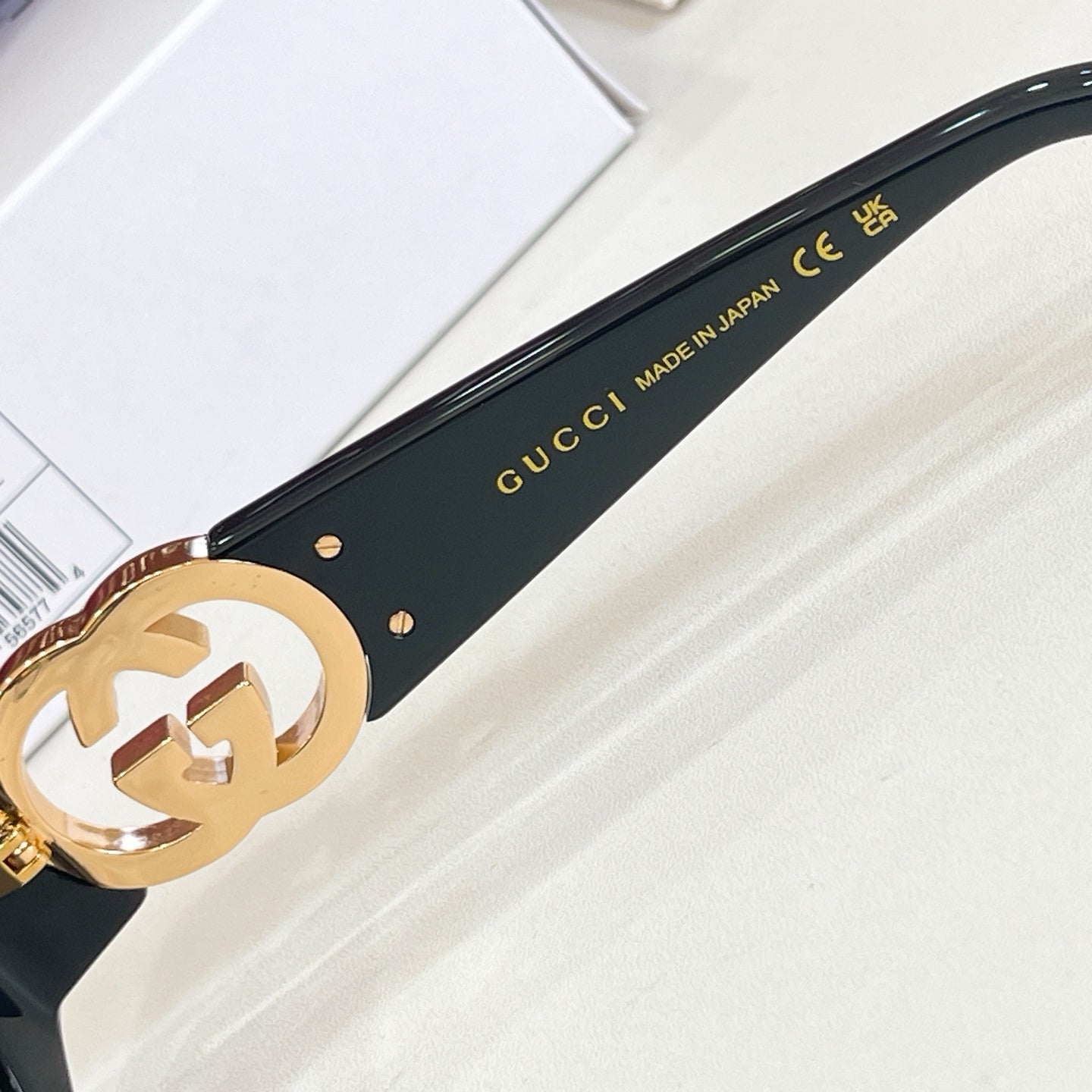 Gucci sunglasses temple with “GUCCI” text and “MADE IN JAPAN” on black frame