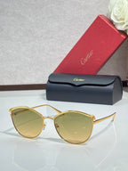 Gold round sunglasses with tinted light amber lenses and slim metal frame, clear bridge detail.