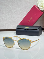 Gold round sunglasses with light blue tinted lenses and slim metal frame, clear bridge detail.