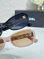 Pink sunglasses close-up with brown lenses and gold CC temple detail