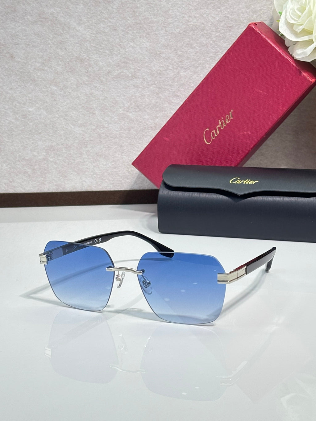 Cartier sunglasses with light blue tinted lenses and gold-tone metal frame, black temples