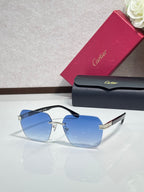 Cartier sunglasses with light blue tinted lenses and gold-tone metal frame, black temples