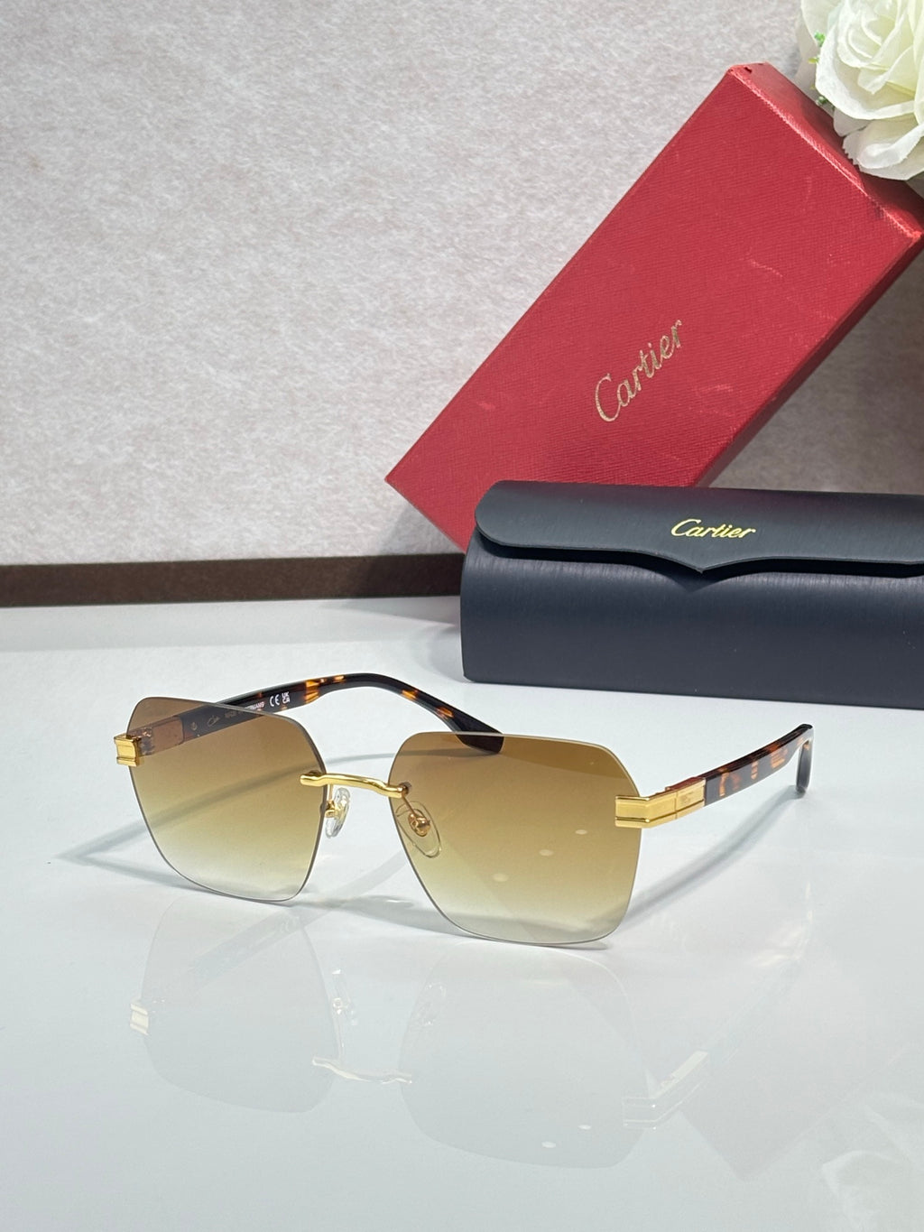 Cartier sunglasses with amber lenses and gold-tone metal frame, black temple tips