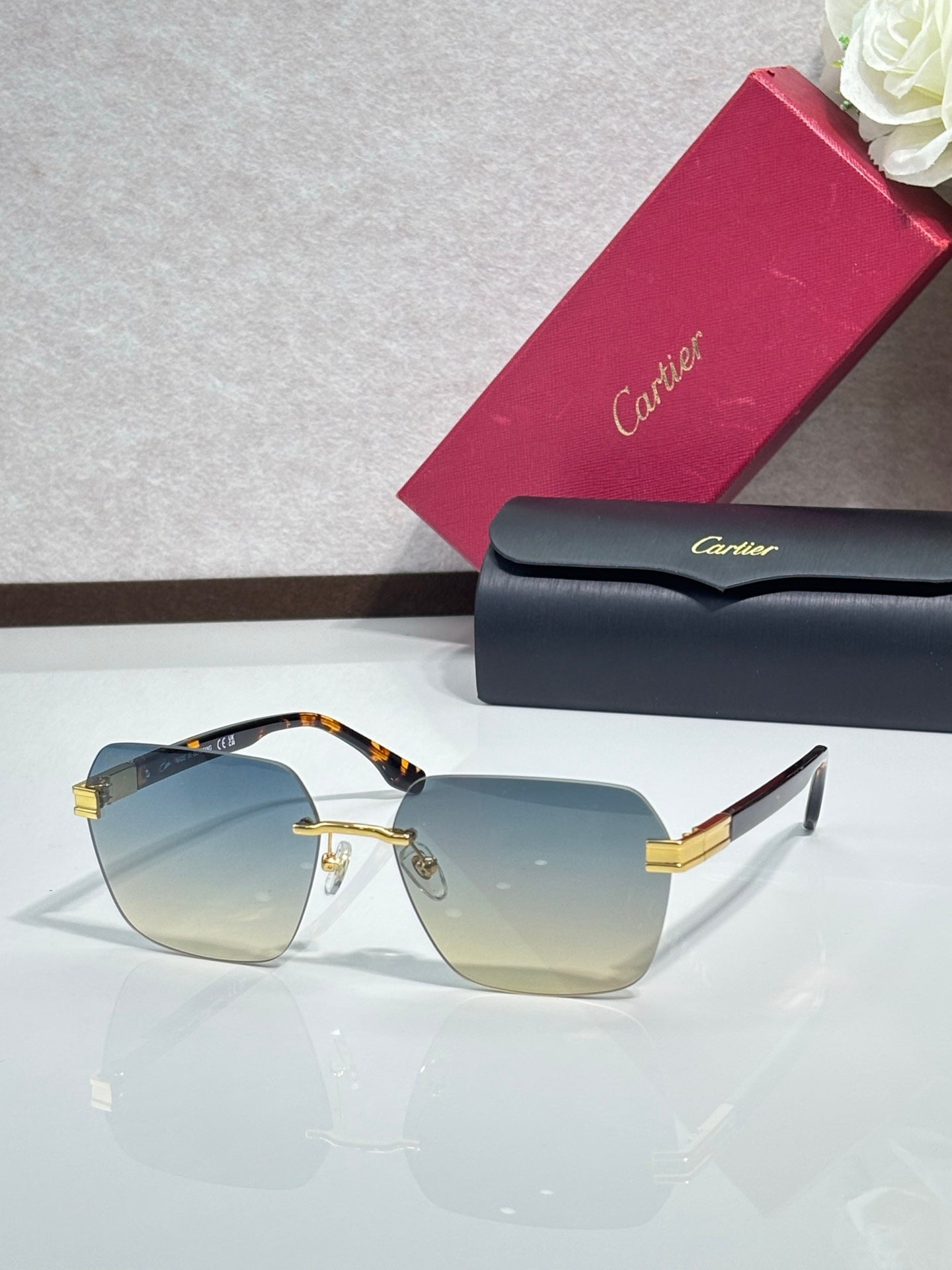 Cartier sunglasses with amber lenses and gold-tone metal frame, black temple accents