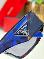 Prada Milano logo on dark sunglasses temple, glossy frame