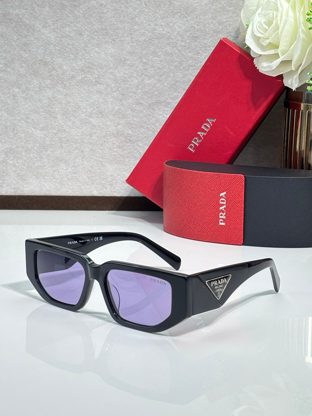 Prada sunglasses with black frames and purple-tinted lenses