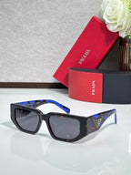 Prada sunglasses with black frames and dark lenses with blue temples