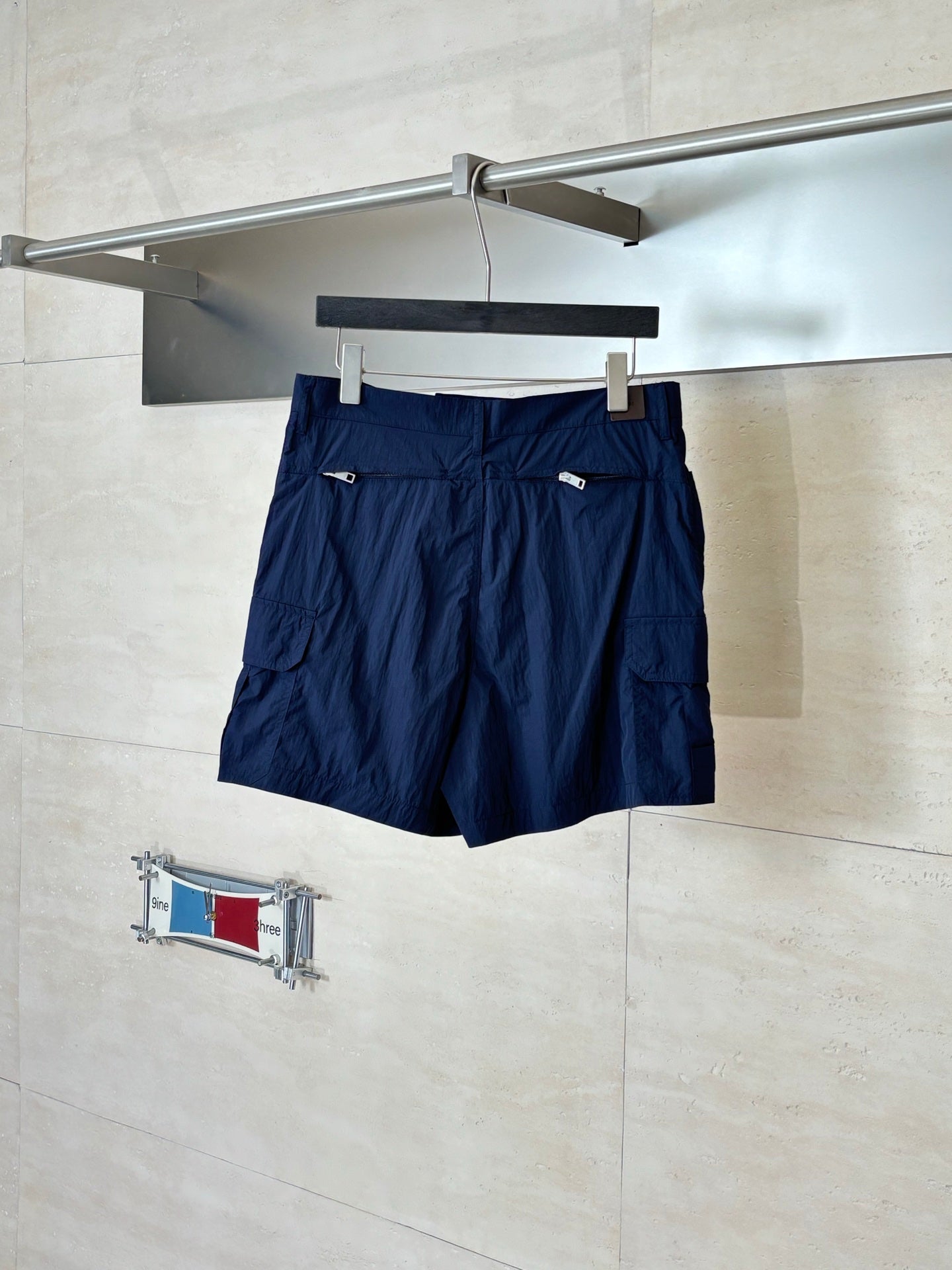 Navy cargo shorts front view with adjustable tabs and belt loops