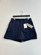 Navy cargo shorts with flap pockets and hanging tag