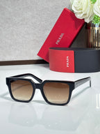 Prada sunglasses with black frame and tan-tinted lenses